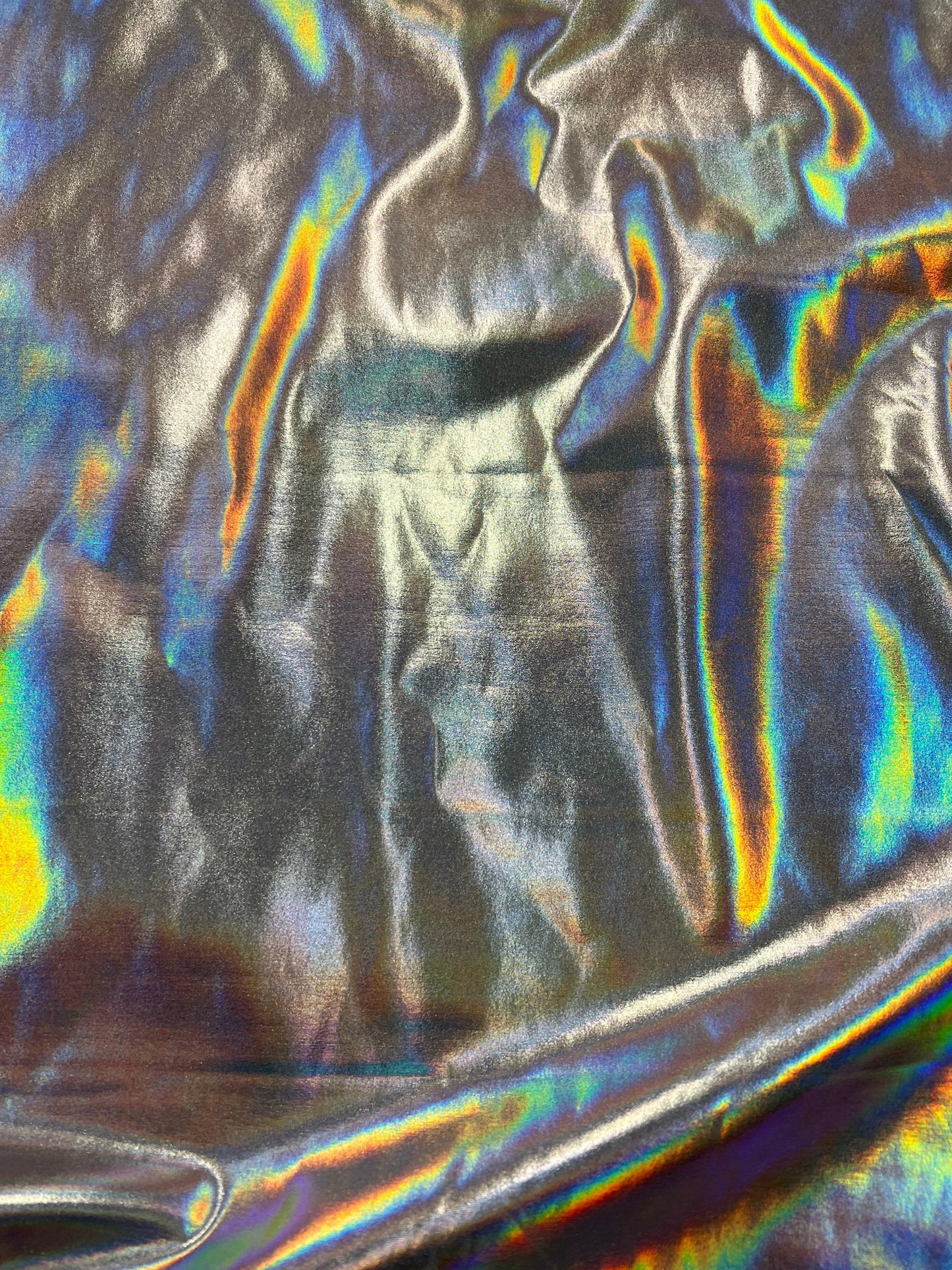 New iridescent/silver all over foil nylon spandex 4-way stretch 58/60”sold by the YD. Ships worldwide from Los Angeles California USA.
