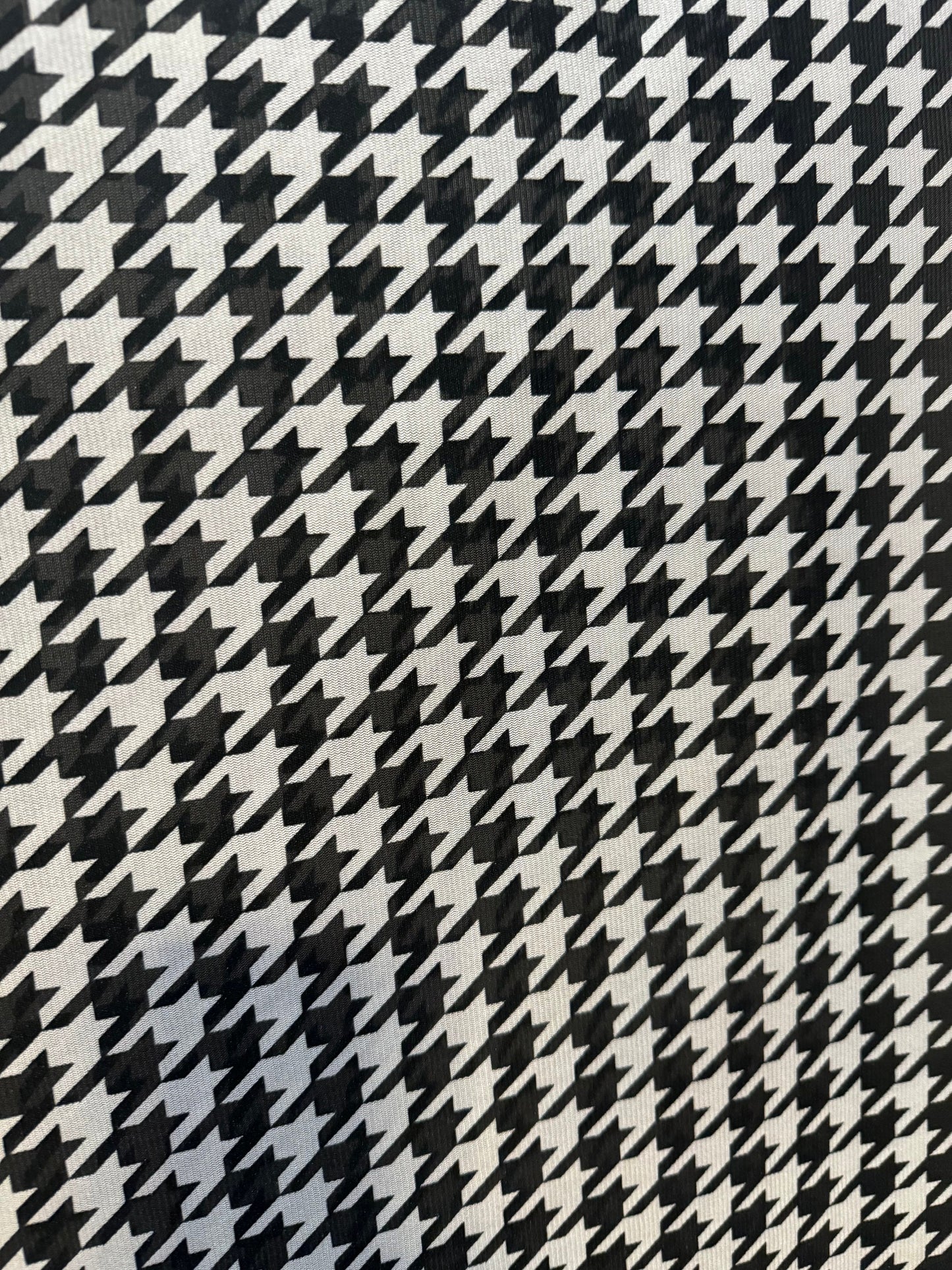 New houndstooth design print on power mesh nylon spandex 4way stretch 58/60”sold by the YD. Ships worldwide from Los Angeles California USA.