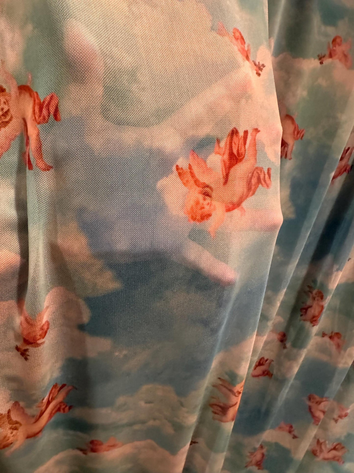 New Cherubim Angels design print on power mesh 4-way stretch 58/60”sold by the YD. Ships worldwide from Los Angeles California USA.