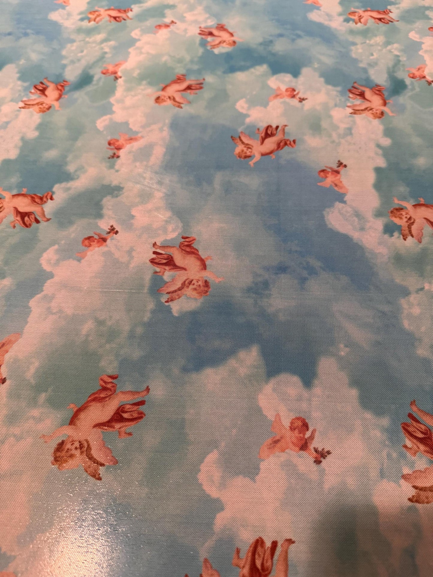New Cherubim Angels design print on power mesh 4-way stretch 58/60”sold by the YD. Ships worldwide from Los Angeles California USA.