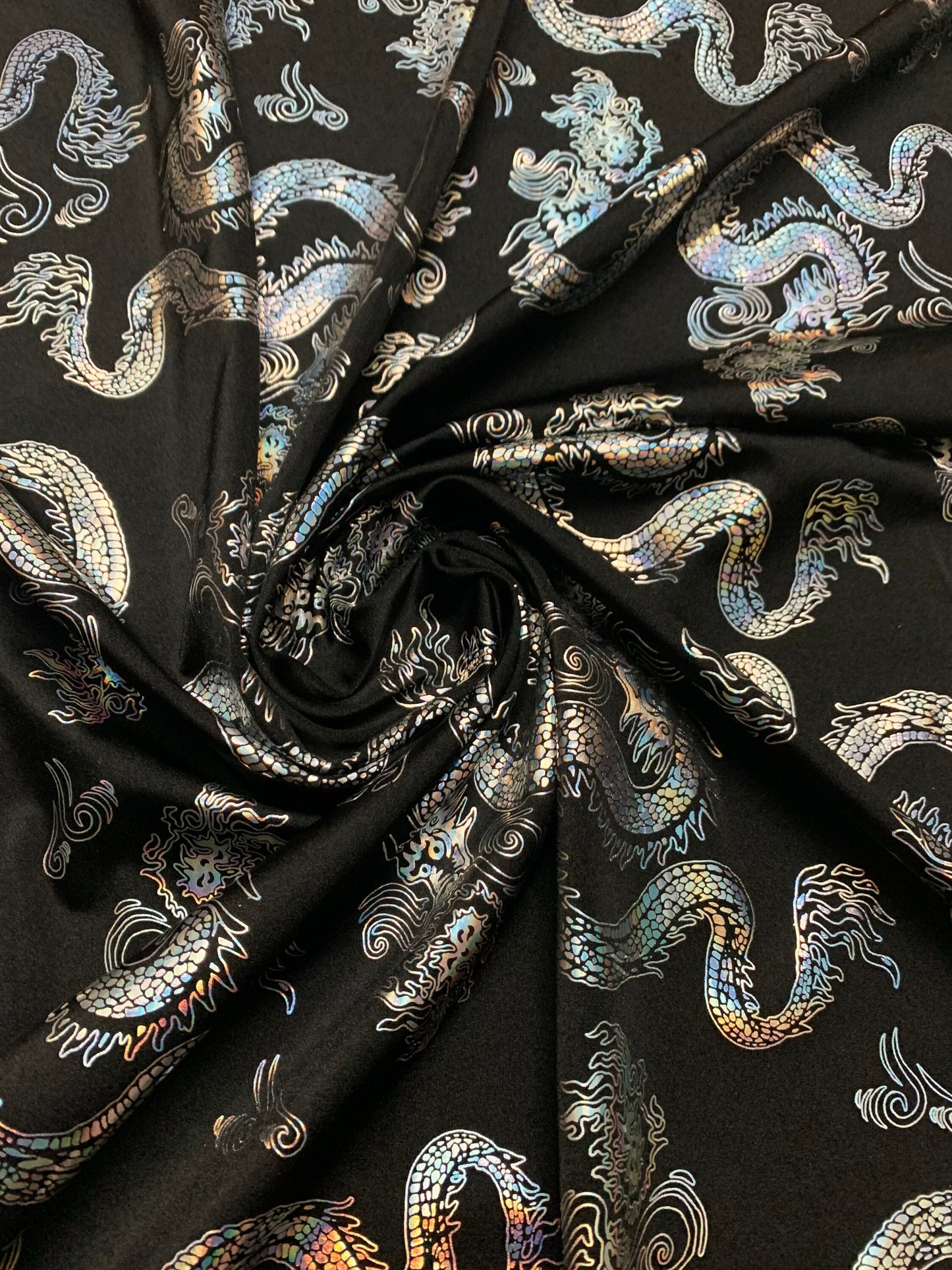 Beautiful iridescent dragon design print on the best quality nylon spandex 4-way stretch 58/60”sold by the YD. ships worldwide from LA