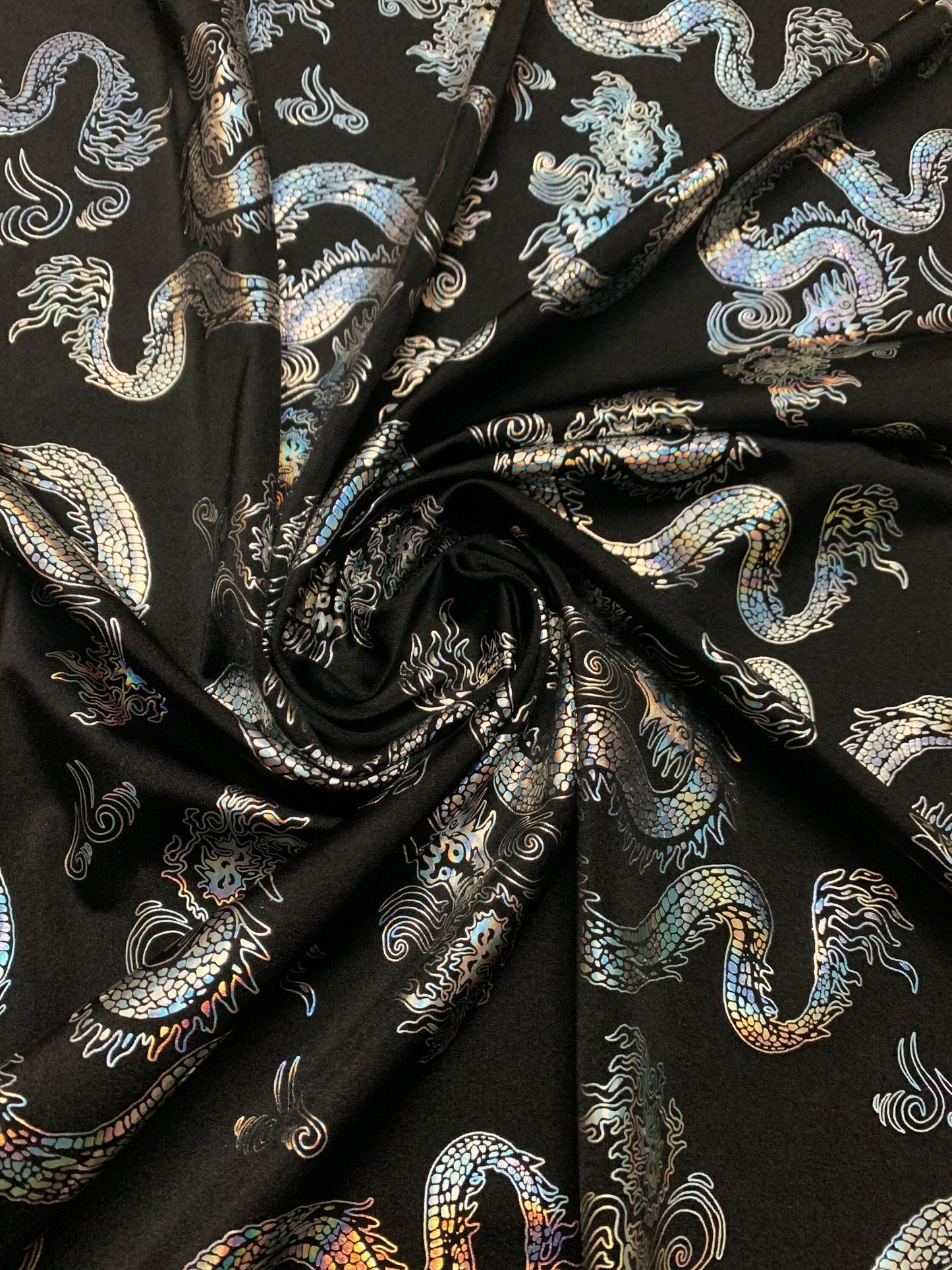 Beautiful iridescent dragon design print on the best quality nylon spandex 4-way stretch 58/60”sold by the YD. ships worldwide from LA