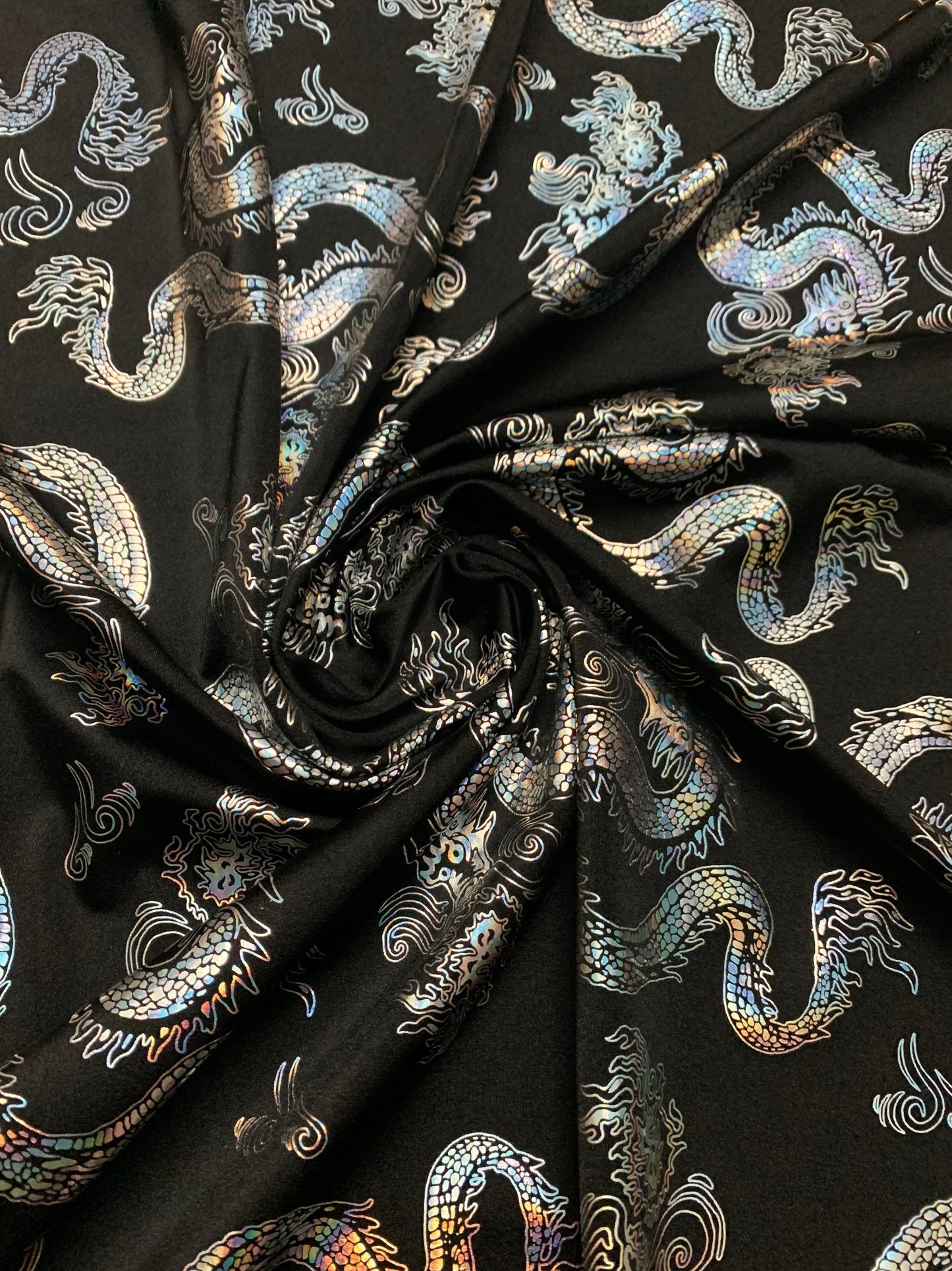 Beautiful iridescent metallic dragon design print on the best quality nylon spandex 4-way stretch 58/60”sold by the YD. ships worldwide from LA