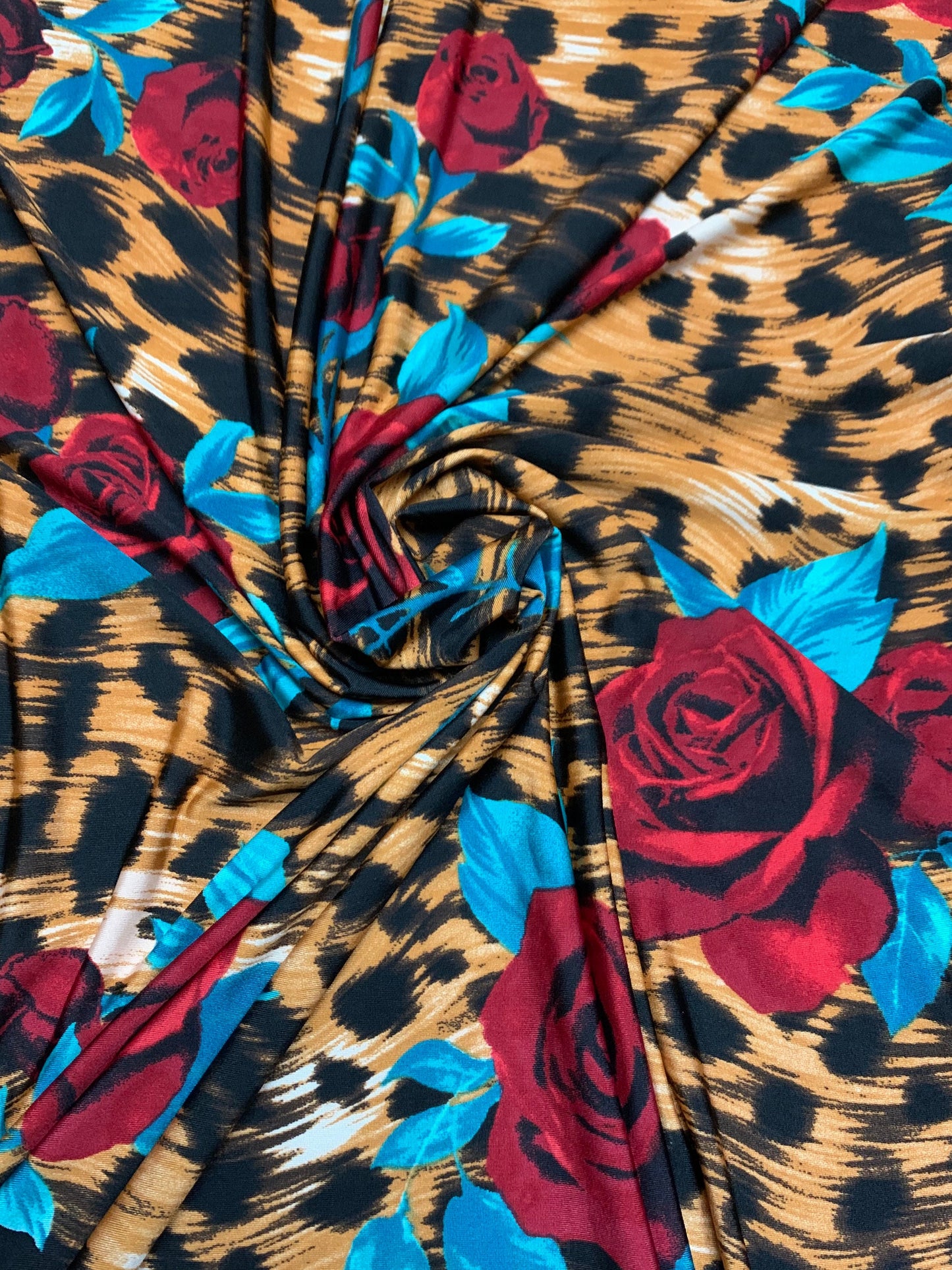 Red roses on leopard design print on poly spandex 4-way stretch 58/60”sold by the YD. ships Worldwide from Los Angeles California USA