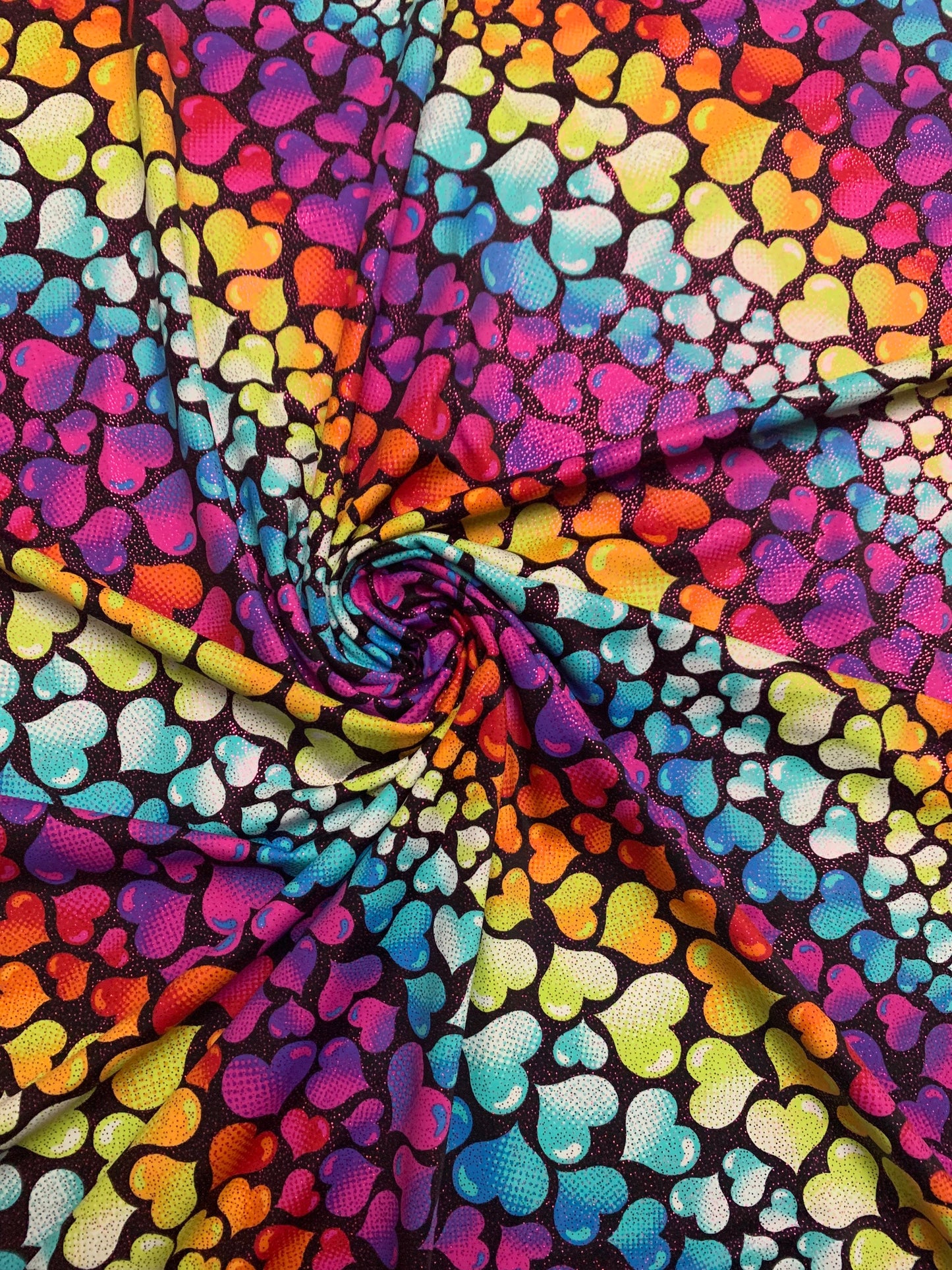 Bright colored hearts design w/foil print nylon spandex 4-way stretch58/60”sold by the YD. ships Worldwide from Los Ángeles CA.