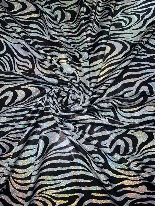 New Holographic zebra design print on metallic nylon spandex 4-Way stretch 58/60”Sold by the YD.Ships worldwide from Los Angeles CA.