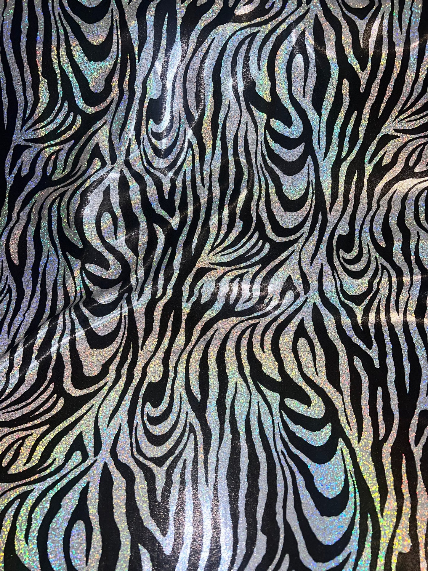 New Holographic zebra design print on metallic nylon spandex 4-Way stretch 58/60”Sold by the YD.Ships worldwide from Los Angeles CA.
