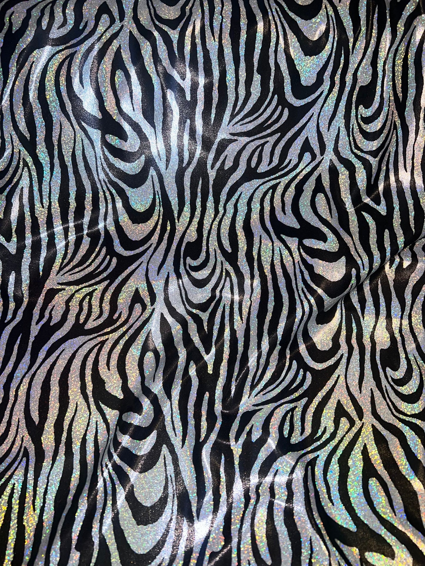 New Holographic zebra design print on metallic nylon spandex 4-Way stretch 58/60”Sold by the YD.Ships worldwide from Los Angeles CA.