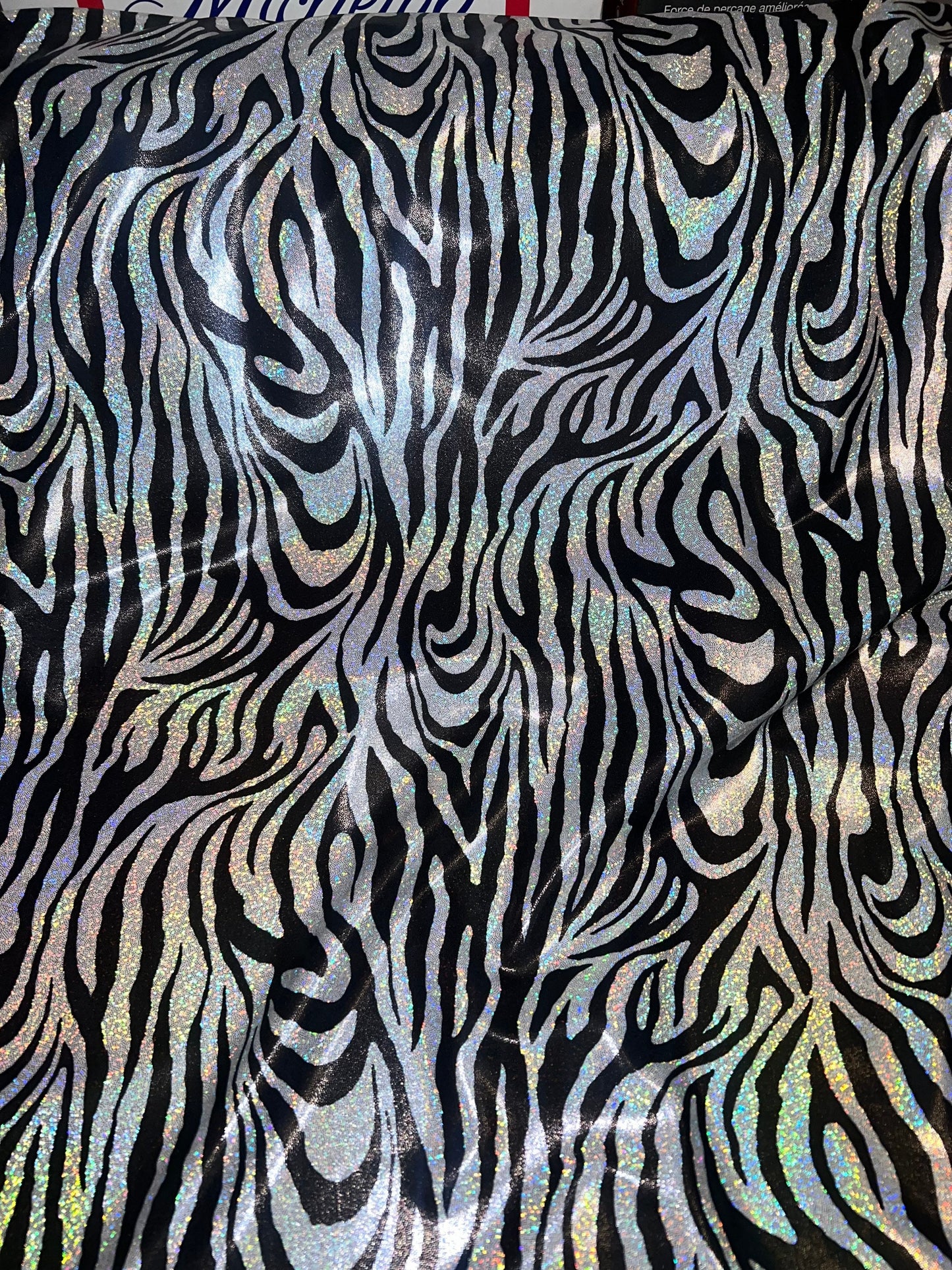 New Holographic zebra design print on metallic nylon spandex 4-Way stretch 58/60”Sold by the YD.Ships worldwide from Los Angeles CA.