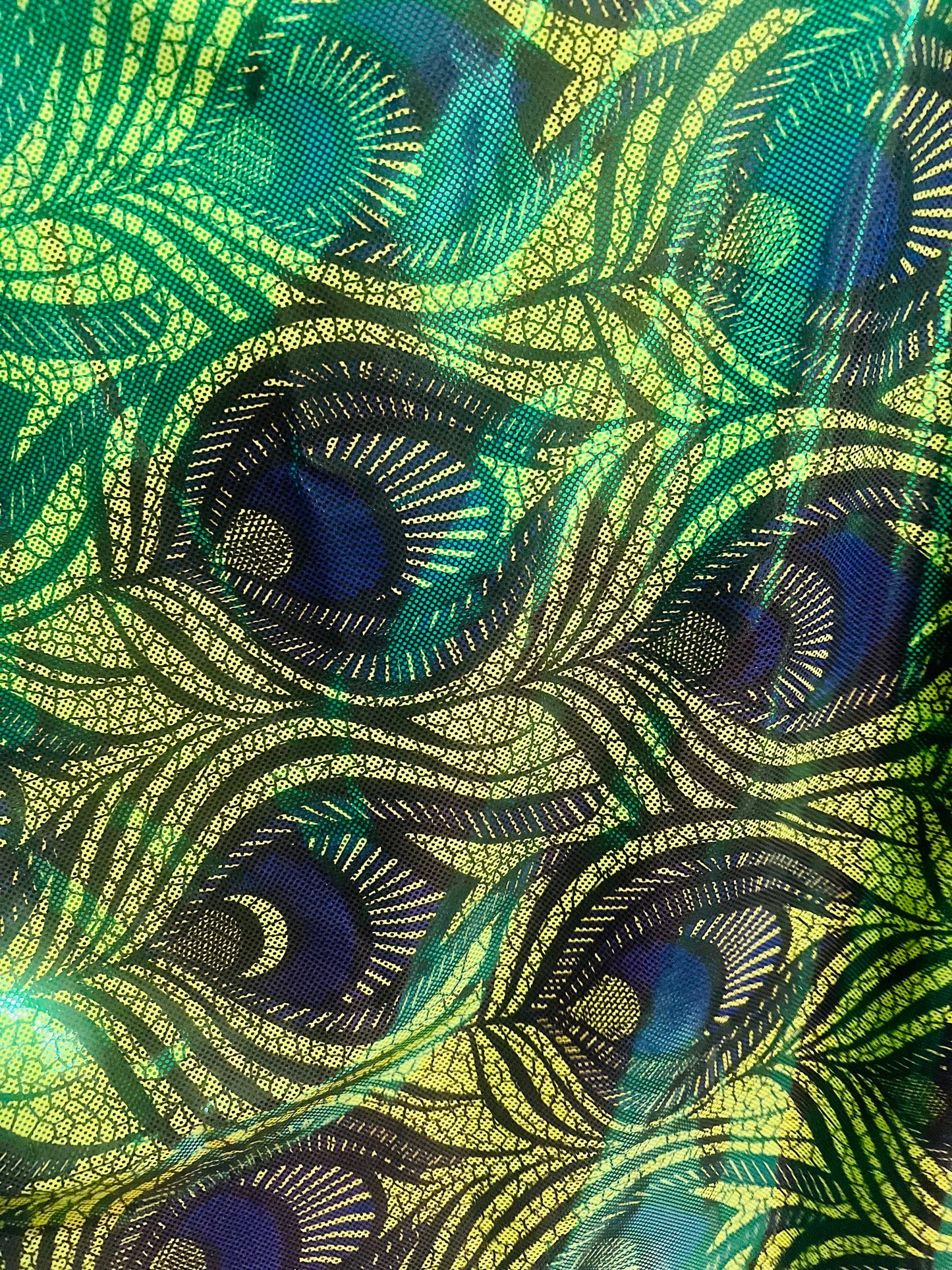 New metallic peacock feathers design print on metallic nylon spandex 4-way stretch 58/60”sold by the YD.Ships worldwide from Los Angeles CA.