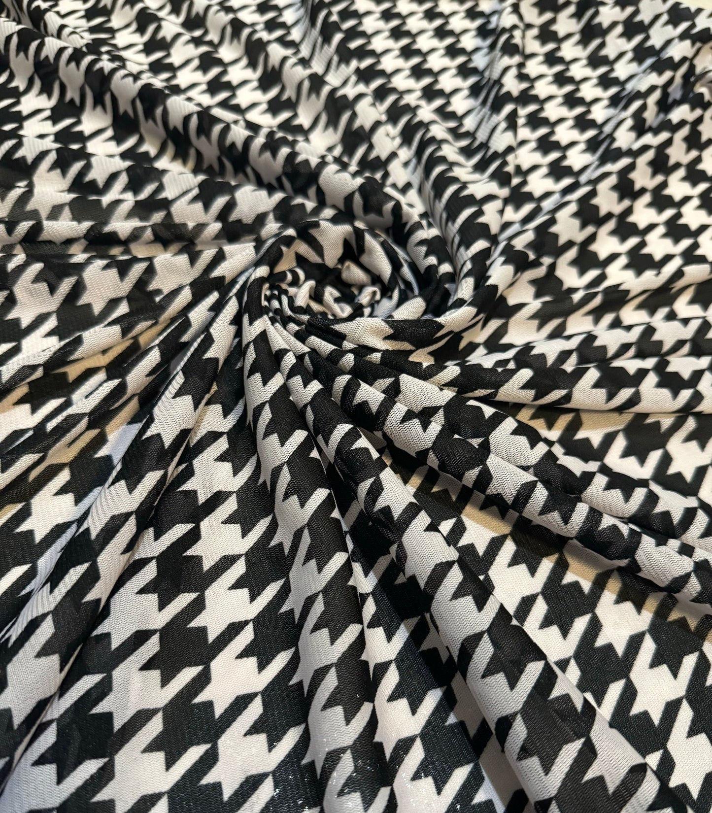 New houndstooth design print on power mesh nylon spandex 4way stretch 58/60”sold by the YD. Ships worldwide from Los Angeles California USA.