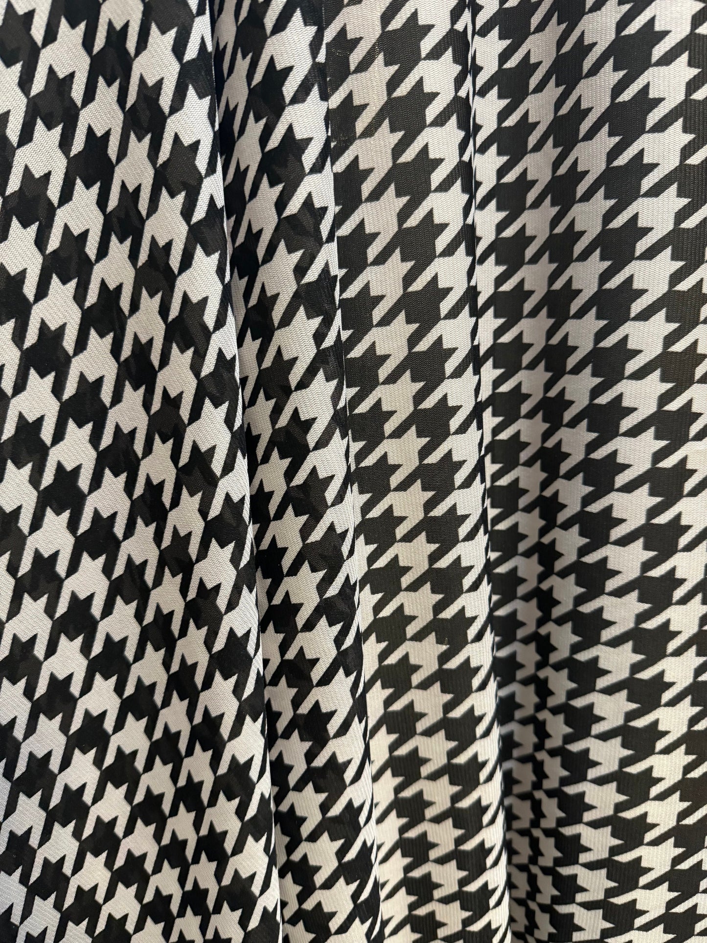 New houndstooth design print on power mesh nylon spandex 4way stretch 58/60”sold by the YD. Ships worldwide from Los Angeles California USA.