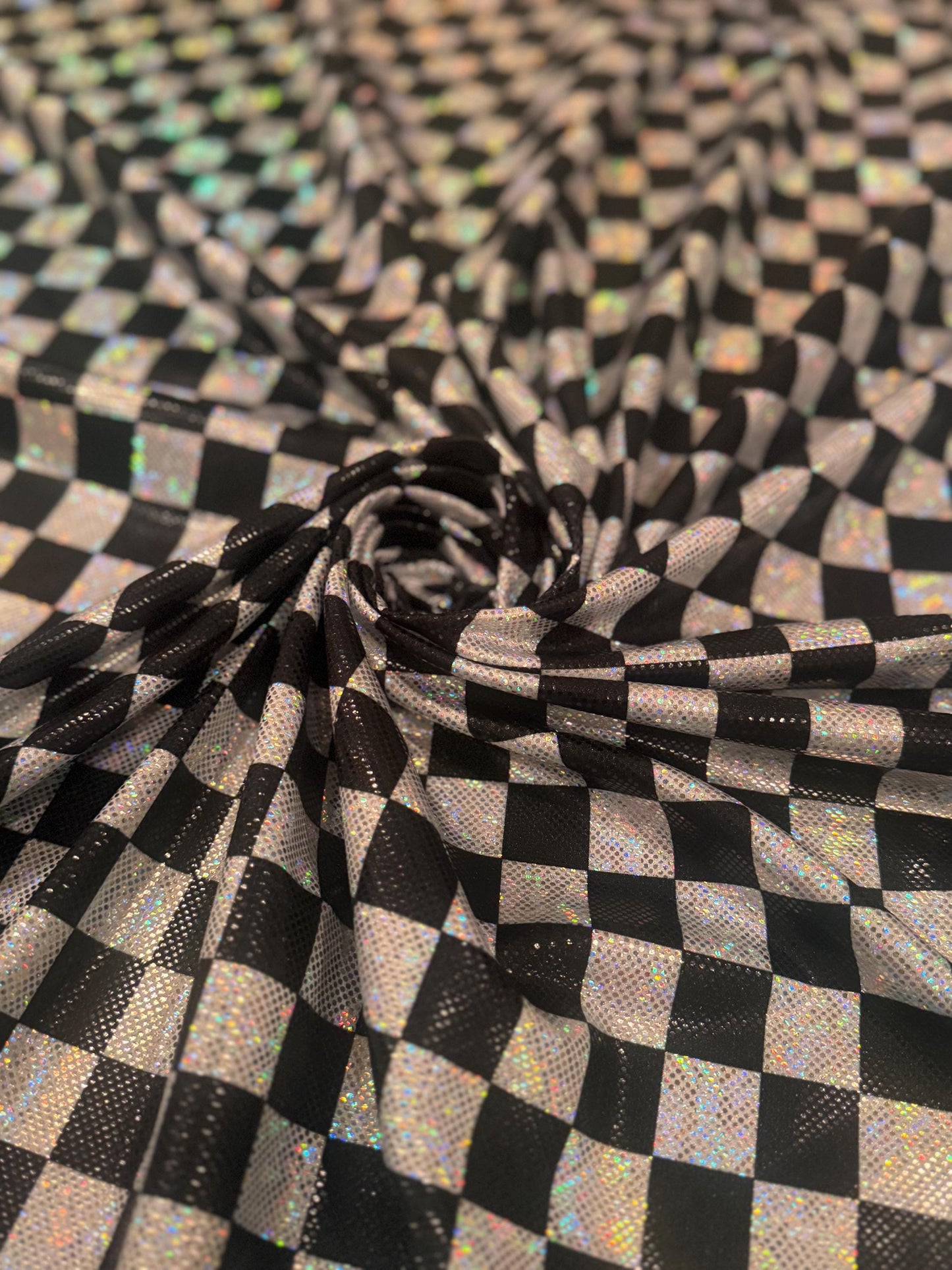 New Checkered pattern design 1”size print on shattered glass holograma metallic nylon spandex 4way stretch 58/60”Sold by the YD.