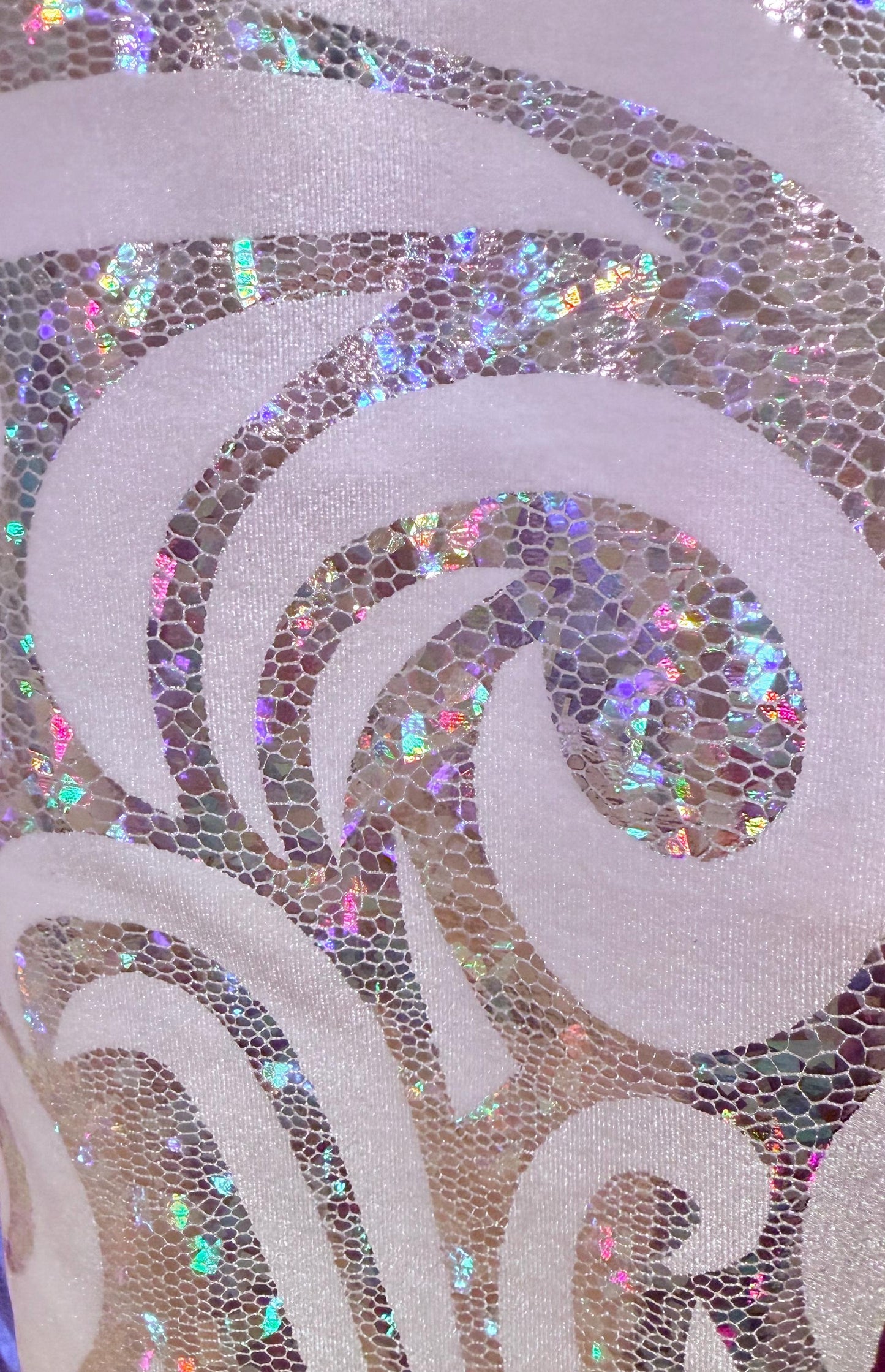 New luxury swirl hologram metallic design on stretch velvet 4-way stretch 58/60”sold by the YD. Ships worldwide from Los Angeles California