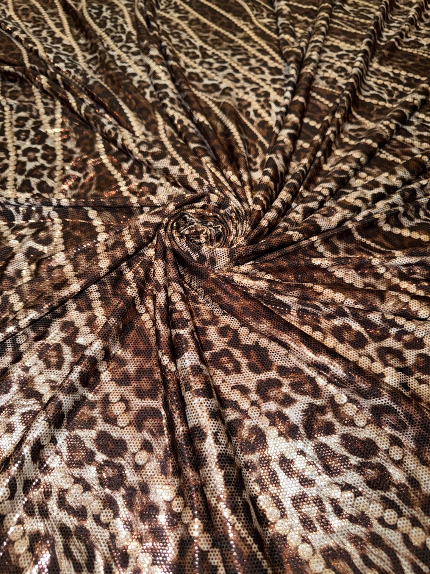 New Skin leopard and pearls design metallic poly spandex 4-way stretch 58/60”Sold by the YD.Ships worldwide from Los Angeles California USA.