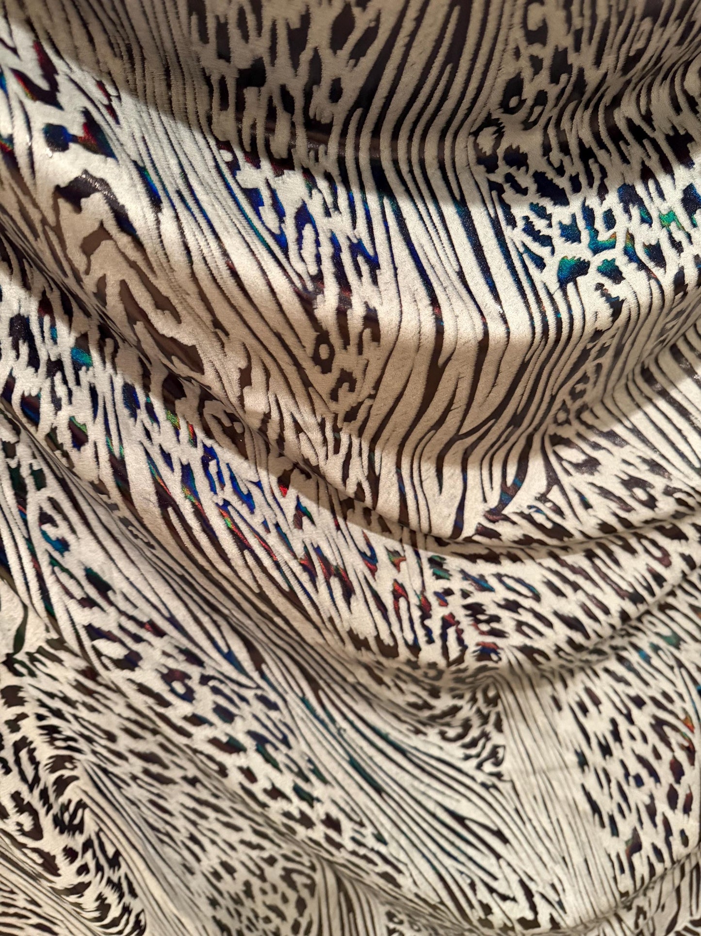 New abstract animal design on metallic hologram nylon spandex4-way stretch 58/60”sold by the YD. ships Worldwide from Los Angeles CA